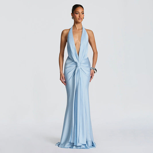 Woman wearing a light blue evening gown on a gray background