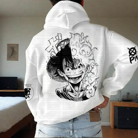 Person wearing a white hoodie with black and white graphic design on the back, in a room setting.