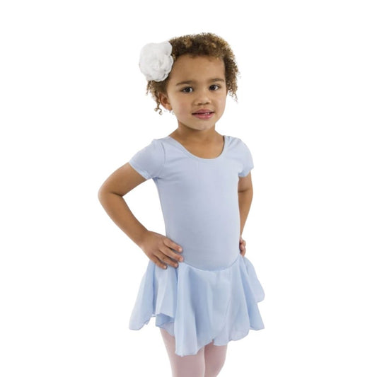 Young girl wearing a light blue dress with a white flower headband on a white background
