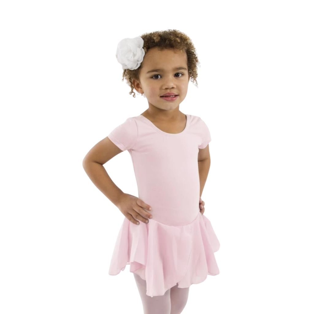 Young girl wearing a pink dress with a white flower headband on a white background