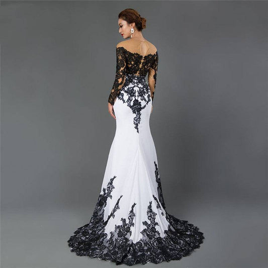 White evening gown with black lace details on a gray background