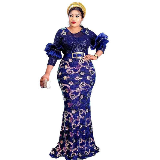 Woman wearing a blue and purple patterned dress with a white background