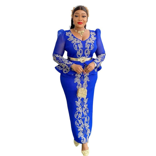 Woman wearing a blue outfit with white embroidery on a white background